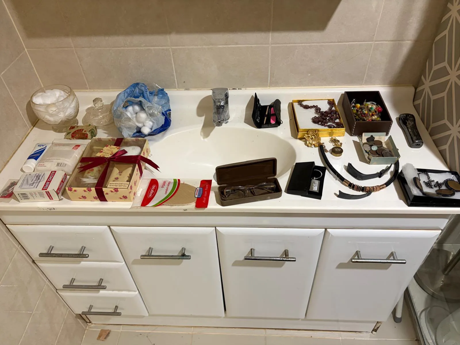 Kitchen and household items arranged on a bench for documentation