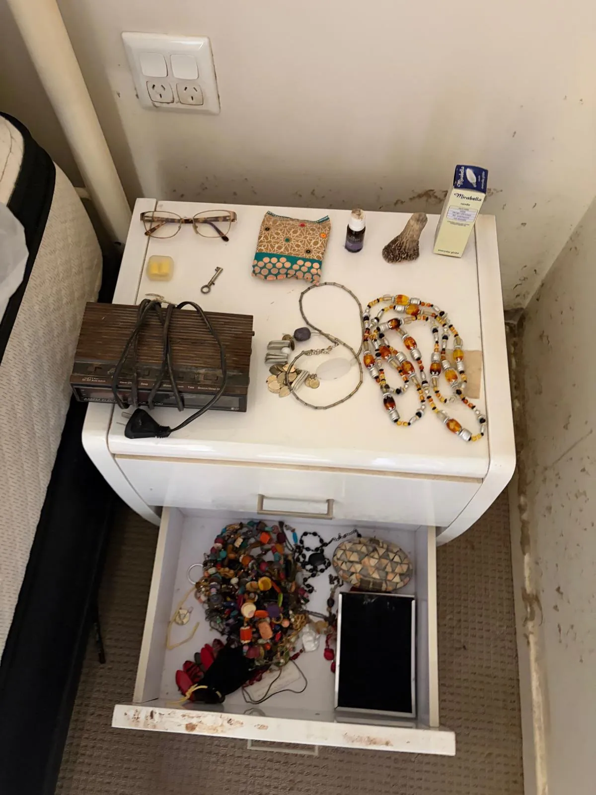 Smaller personal items photographed on drawers during a contents record