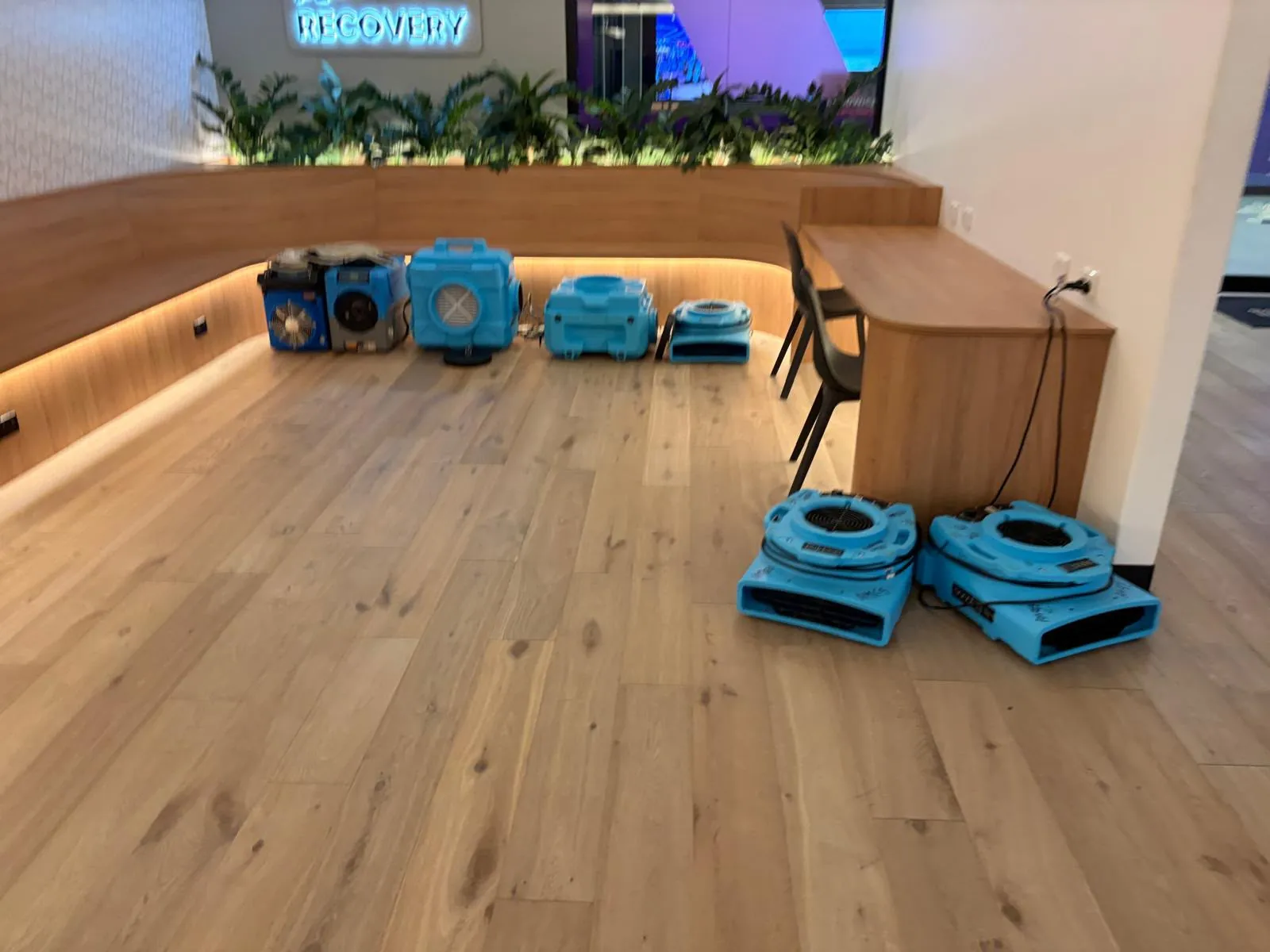 Air movers on flooring: Machines positioned along affected floors.