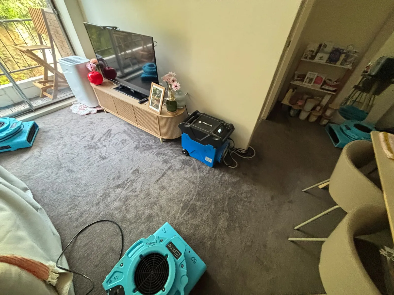 Room drying setup: Air movers positioned around an affected interior.